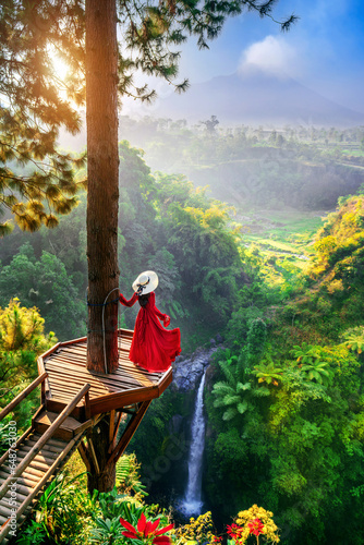 Tourist standing at Air Terjun Kedung Kayang waterfall at sunrise  Indonesia.