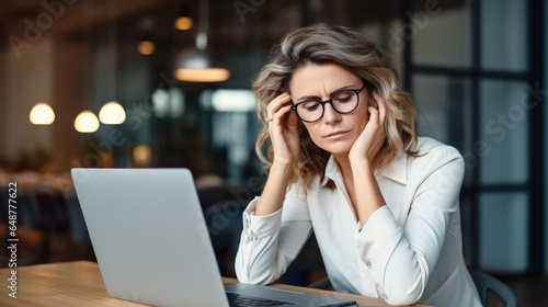 Business woman wearing glasses having headache at work, Stress at workplace.