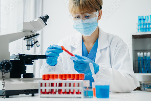 Modern medical research laboratory. female scientist working with micro pipettes analyzing biochemical samples, advanced science chemical laboratory