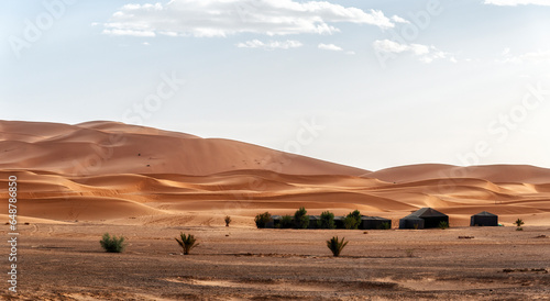Camp site with tents over sand dunes in Sahara desert, Morocco © atosan