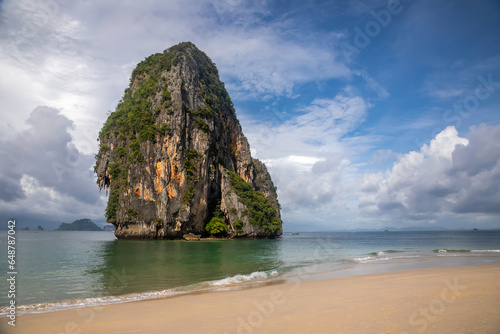 Small island with trees in the water. Beautiful sea in Thailand. Sandy beach. Sunny morning.