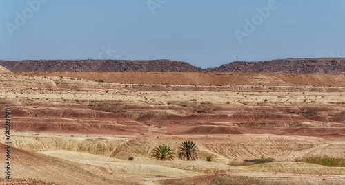 landscape with orange sand dunes and mountains in Morocco