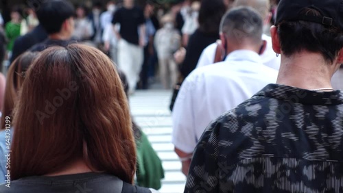 Wallpaper Mural Slow motion shot of crowd of people walking in Osaka, Japan. Back shot of unidentified men and women. Shot in sunset time, busy rush hour. Japanese people and urban city lifestyle concept video. Torontodigital.ca