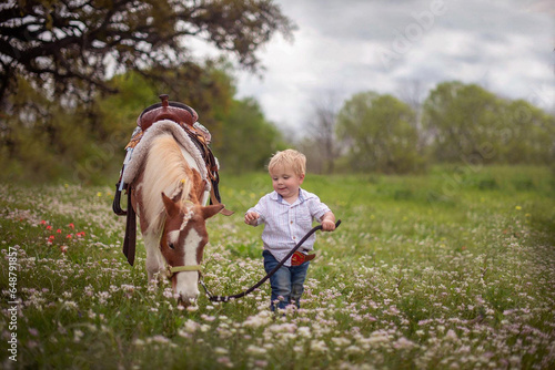 Boy and His Pony in Wildflower Field photo