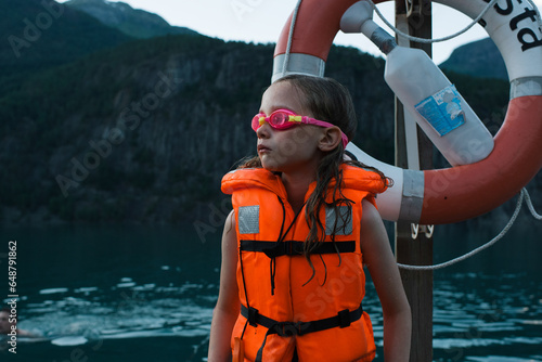 girl looking very cold waiting to swim in the sea in Norway photo