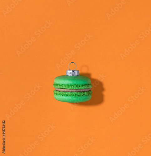 Christmas macaroon bauble on orange background photo