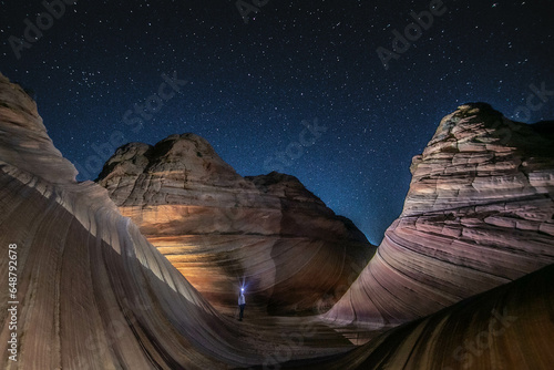 A solitary hiker at the Wave, Arizona, before dawn photo