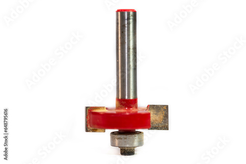 Used, red rabbet router bit close up shot on white background.