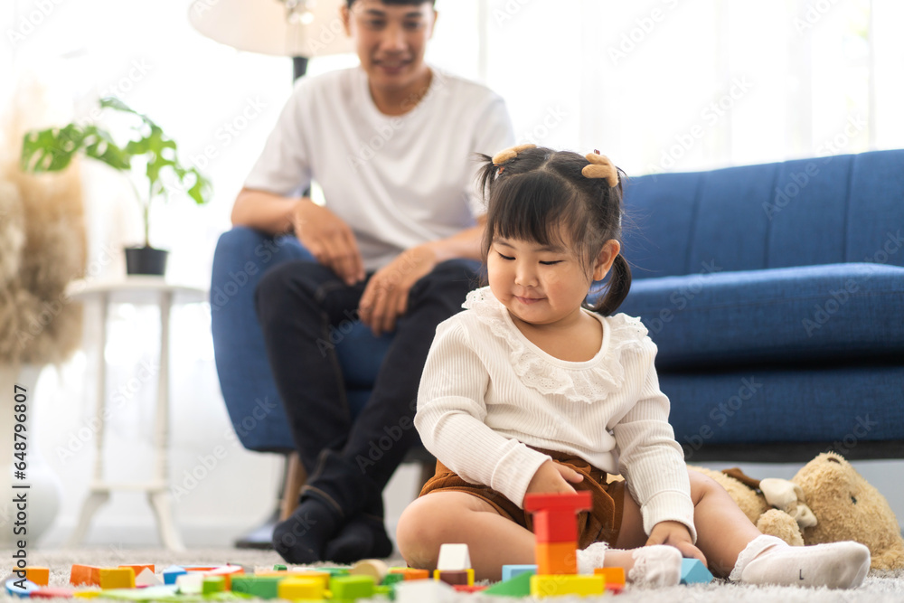 Obraz premium Portrait of enjoy happy love asian family father and little asian girl smiling activity learn and skill brain training play with toy build wooden blocks board education game at home