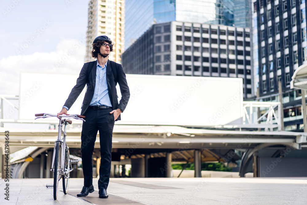 Portrait of hipster handsome businessman in suit with backpack looking forward while commuting riding bicycle on the street city way go to work.business travel transport bike concept Portrait of hipster handsome businessman in suit with backpack looking forward while commuting riding bicycle on the street city way go to work.business travel transport bike concept