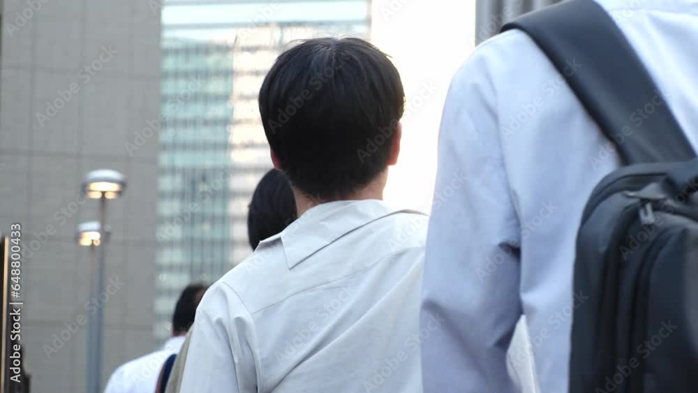 View of crowd of people walking in Osaka, Japan. Back shot of unidentified men and women. Shot in sunset time, busy rush hour. Japanese people and urban city lifestyle concept video. View of crowd of people walking in Osaka, Japan. Back shot of unidentified men and women. Shot in sunset time, busy rush hour. Japanese people and urban city lifestyle concept video.