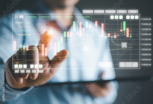 Businessman using finger touching chart to analyze the stock market trending. Finance strategy to success the marketing investment.