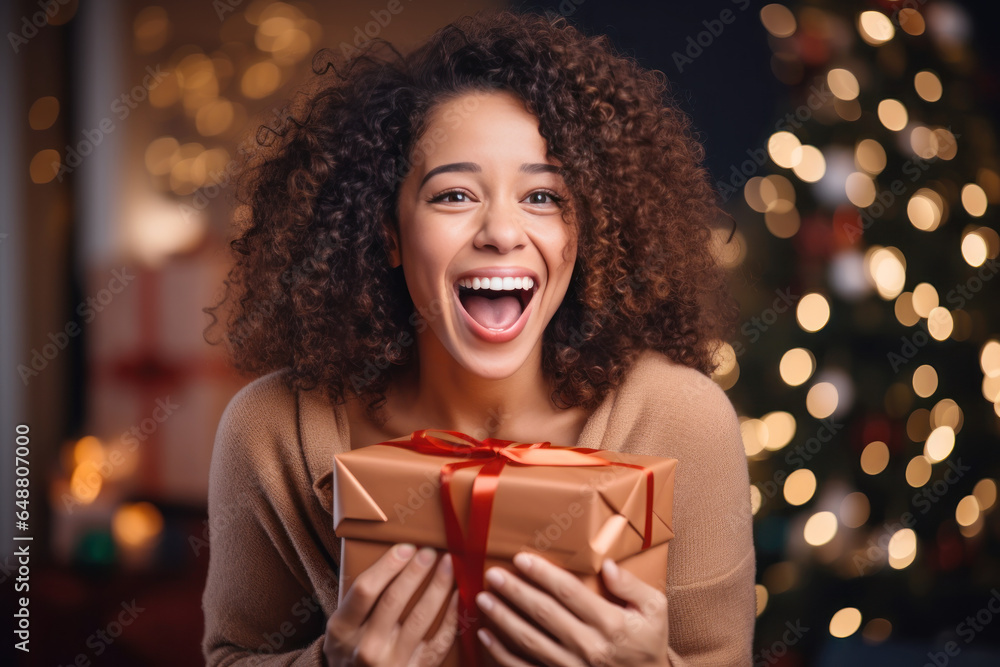 African woman smile shaking christmas present, happy female gets gift - obrazy, fototapety, plakaty 