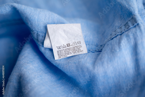 Clothing label on light blue garment, top view
