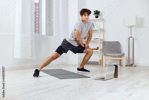 man indoor gray sportswear lifestyle dumbbells health activity home training sport