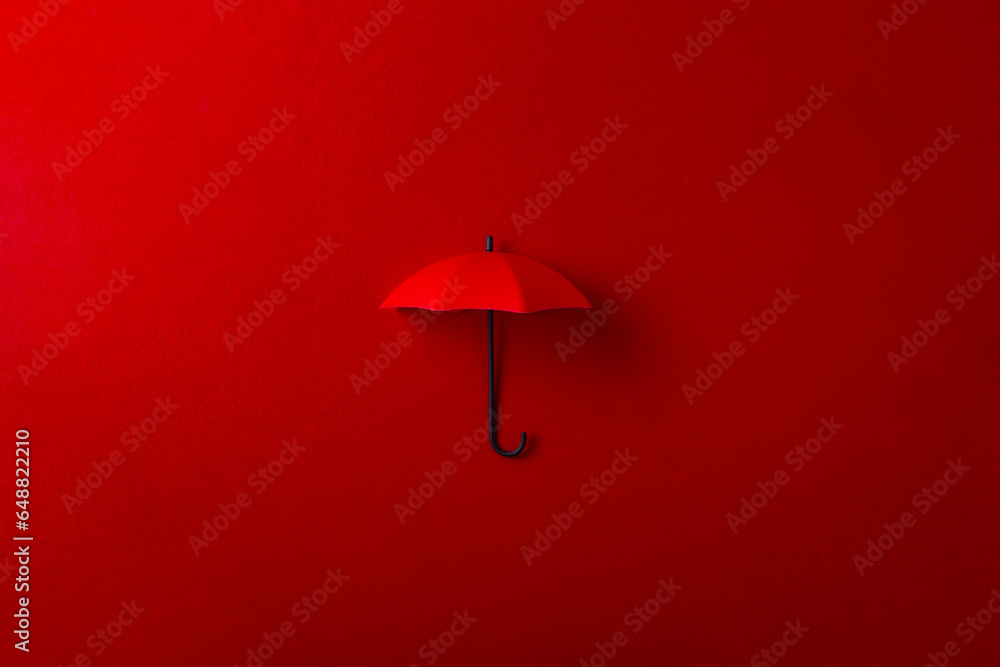 Red umbrella isolated on purple background.