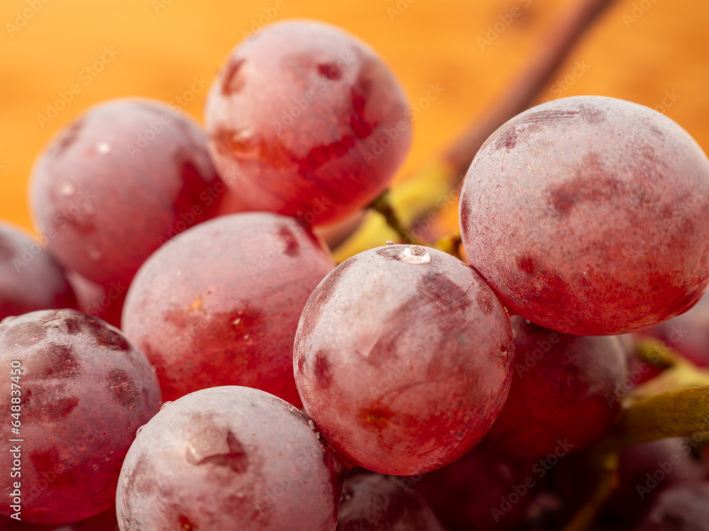 Obraz premium Red grapes on a wooden background. Ripe grapes close-up.