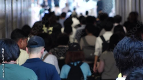 Wallpaper Mural TOKYO, JAPAN - JULY 2023 : Crowd of people walking at the street near Shinjuku station in busy rush hour. Japanese people, urban city life and lifestyle concept video. Slow motion shot. Torontodigital.ca