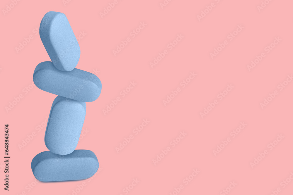 Blue capsules, pills and tablets flying up. On a pink background. Blue capsules, pills and tablets flying up. On a pink background.