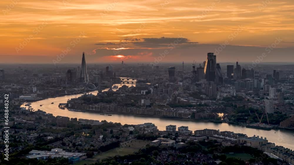 Panoramic sunset to night time lapse view of the urban skyline of London, United Kingdom, with River Thames and the City skyscrapers
