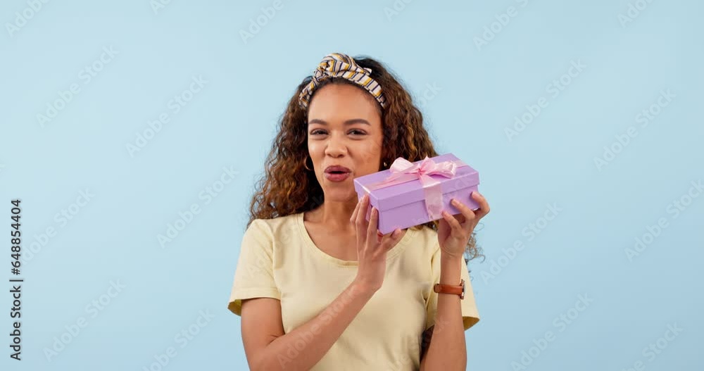 Excited, woman shake present and box in studio isolated on a blue background mockup space. Portrait, happy person guessing gift package and curious at party, birthday celebration and holiday prize Excited, woman shake present and box in studio isolated on a blue background mockup space. Portrait, happy person guessing gift package and curious at party, birthday celebration and holiday prize