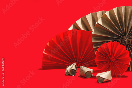 Happy Chinese New Year traditional concept. Oriental asian style paper fans on red background