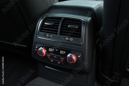 Close up dual-zone car climate control for rear passengers. Climate control dashboard display. Luxurious car air conditioner.