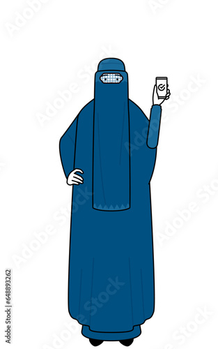 Muslim woman in burqa using a smartphone at work.