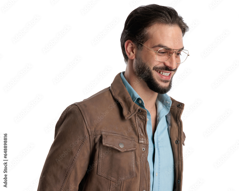 enthusiastic young man with glasses laughing and looking to side enthusiastic young man with glasses laughing and looking to side