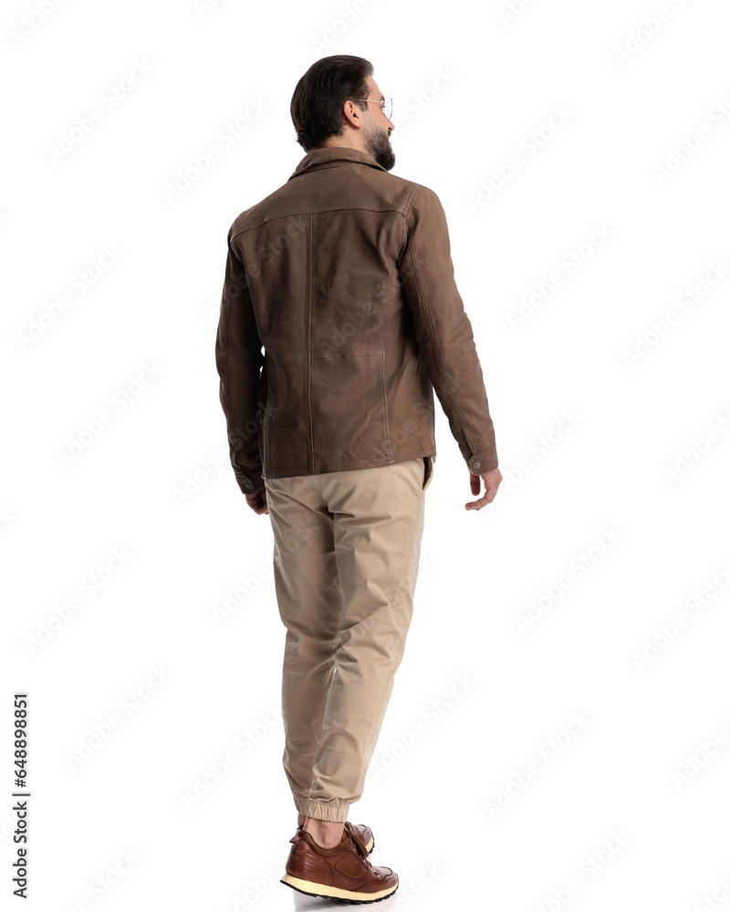 cool young guy with glasses looking away, smiling and walking cool young guy with glasses looking away, smiling and walking