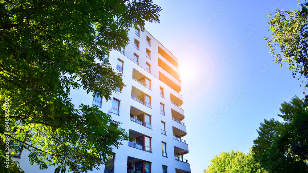Image showcasing Modern apartment building and green trees. Ecological housing ...