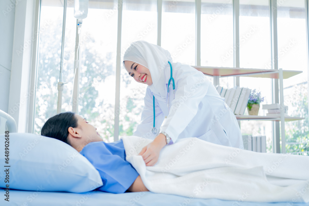 asian muslim woman doctor working with smiling and freshness together to takecare ill patient in hospital. asian muslim woman doctor working with smiling and freshness together to takecare ill patient in hospital.