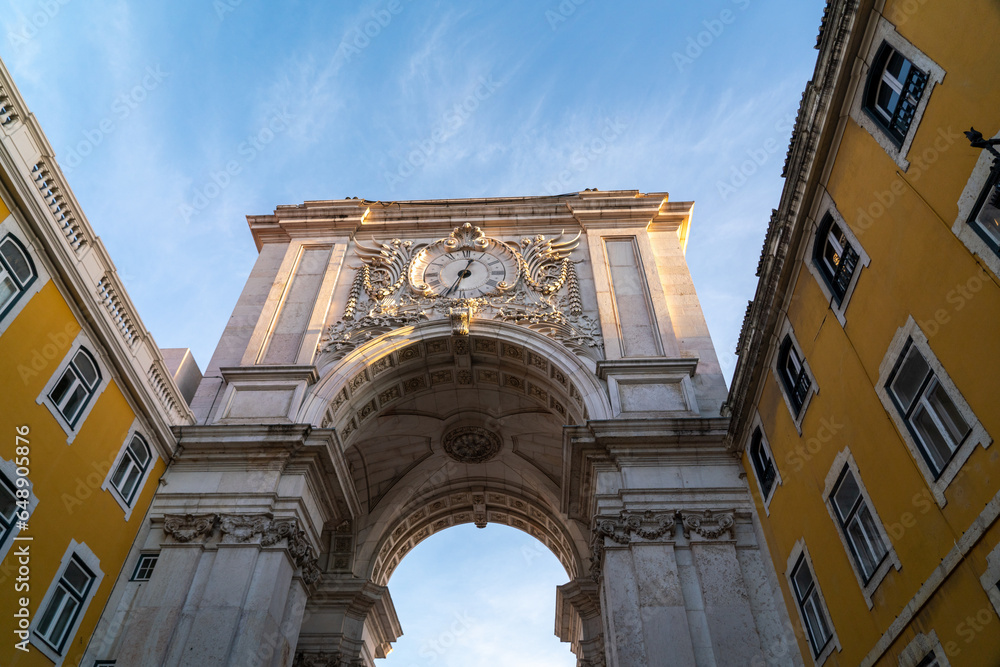 Spectacular Arco da Rua Augusta - Lisbon - Portugal. Richly ornamented triumphal arch, from the c. XVIII, with carved figures and views towards the city center.. Beautiful sunset colours
