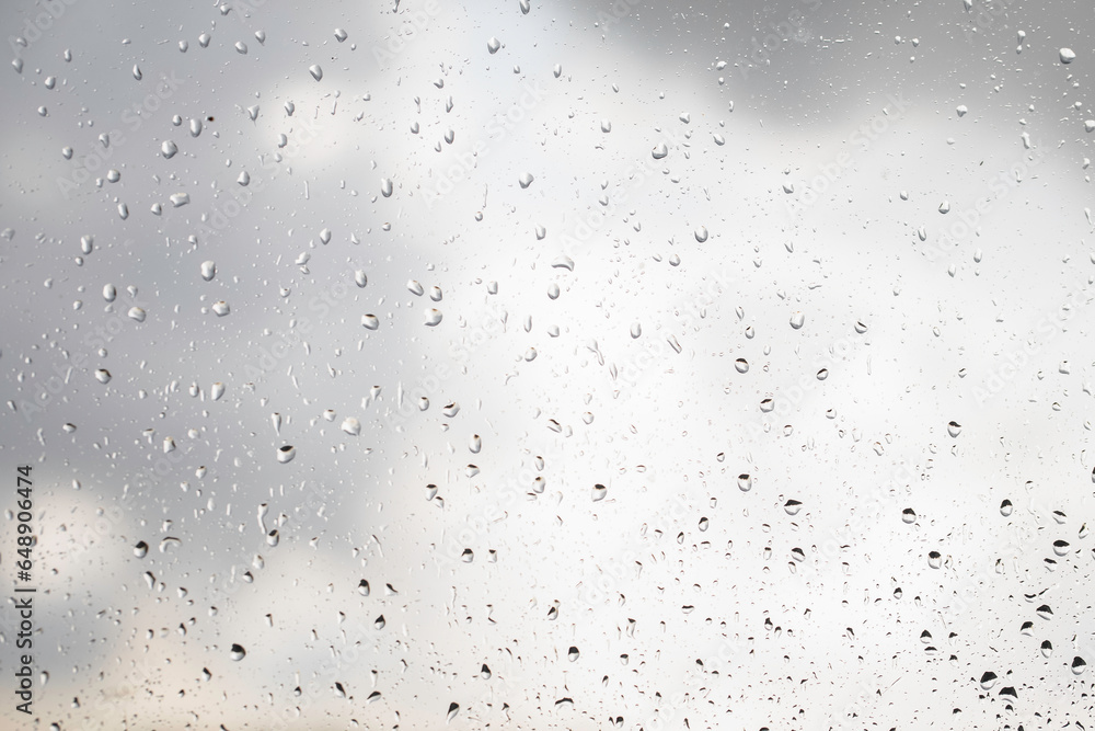 Water drops on the window pane, glass. Defocused lights of the city. Bokeh - abstract background. Colorful and vivid. Water drops on the window pane, glass. Defocused lights of the city. Bokeh - abstract background. Colorful and vivid.