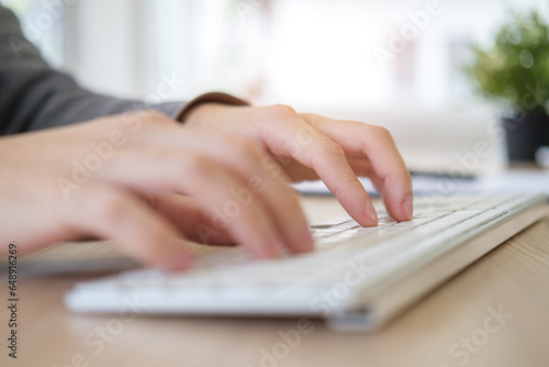 Close up view young woman freelancer hands typing on keyboard of computer.