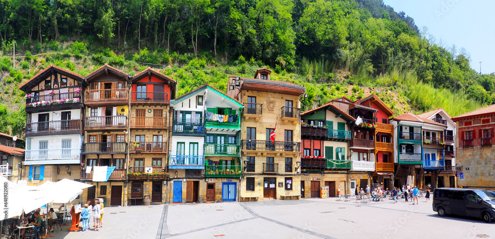 Fototapeta premium Santiago Plaza is a hidden gem in Pasaia Donibane, Spain, near San Sebastian. Nestled in this charming Basque fishing village, it is a picturesque riverside square lined with colorful buildings
