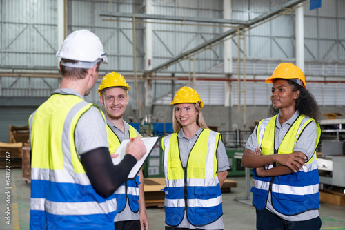 Supervisor engineering meeting with male and female engineers teams in factory industry. Teamwork professionals discuss together in carton sheet production manufacturing factory