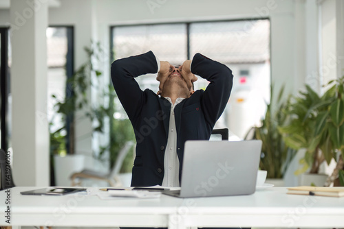 Obraz na płótnie Young unhappy man office worker feeling bored at work, looking at laptop with de