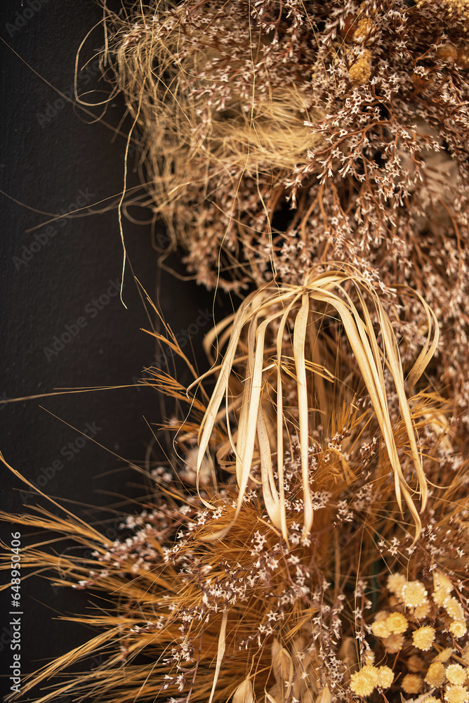 Decor of dried flowers on the wall. A bouquet of dried flowers. Floral minimalist home interior in boho style. The decor of the festive photo zone in the boho style.