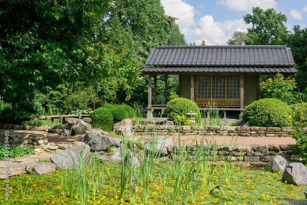 tea house near pond in japanese garden