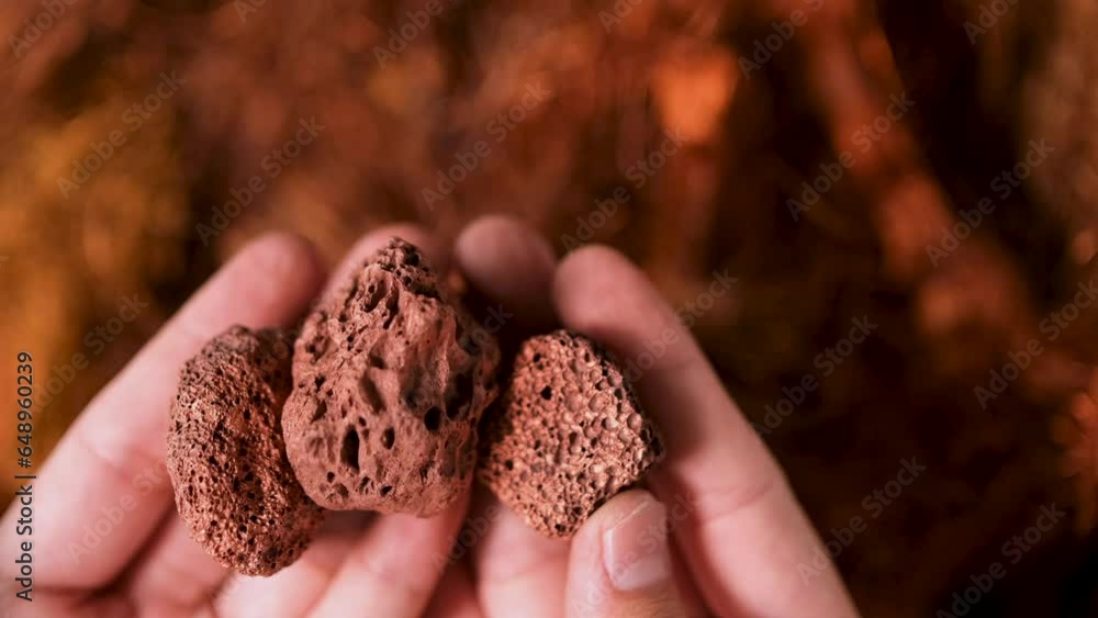 Man's hand holding a piece of copper to examine it for industrial use on white background Man's hand holding a piece of copper to examine it for industrial use on white background