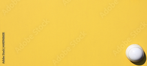 Yellow wall, texture, background. The wooden wall, painted with enamel paint. Flat surface in yellow color. Smooth and glossy surface with a yellow tint