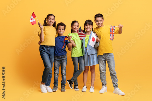 Fotografie Smiling diverse children with flags of different countries in hands