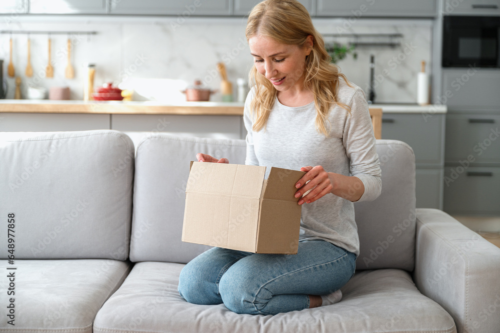 Female unpacking carton parcel order at home Female unpacking carton parcel order at home