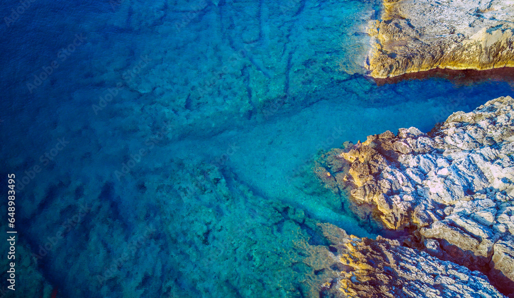 Drone perspective of beautiful rocky beach with turquoise sea water at the Korcula island, Croatia during first morning light