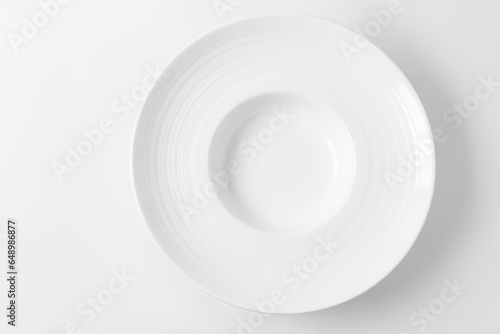 Empty large white plate on a white background, top view