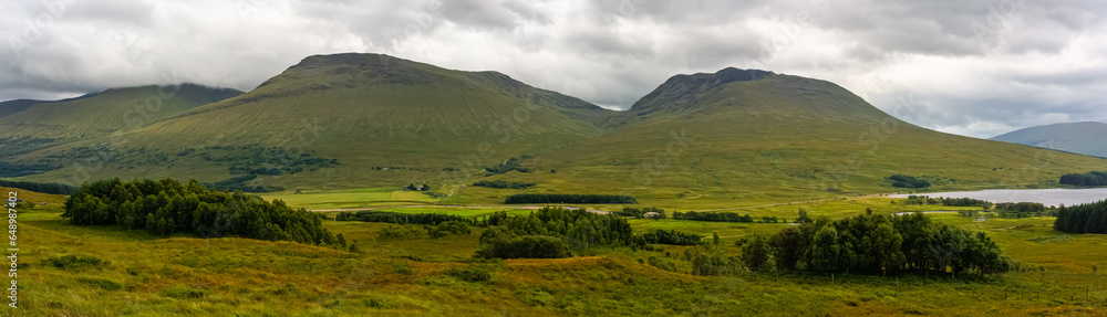 Great panorama of the mountainous and green landscape with lakes of the Glencoe Valley, Scotland