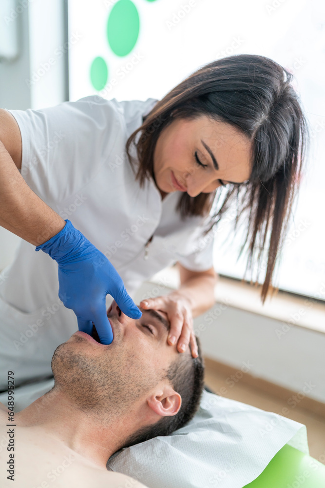 Professional massage specialist curing patient in clinic Professional massage specialist curing patient in clinic