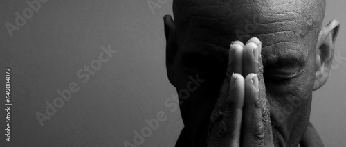 man praying to god with hands together Caribbean man praying on black background with people stock photos stock photo	