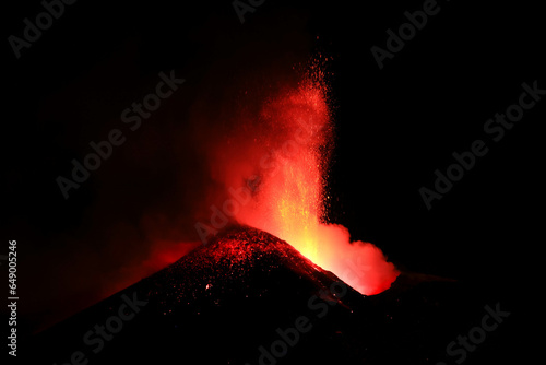 Vulcano Etna in Sicilia - Cratere in eruzione visto di notte in dettaglio in primo piano durante un attività vulcanica con esplosioni di lava ad Agosto 2023	 photo